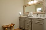 Commodious full-bathroom features double sink vanity cabinet